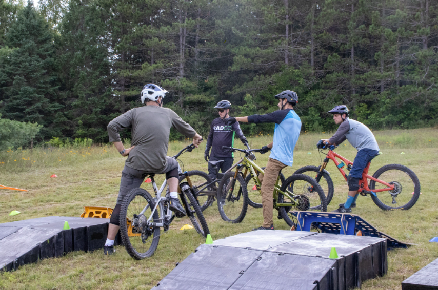 Mountain Bike Lessons Jumping group back